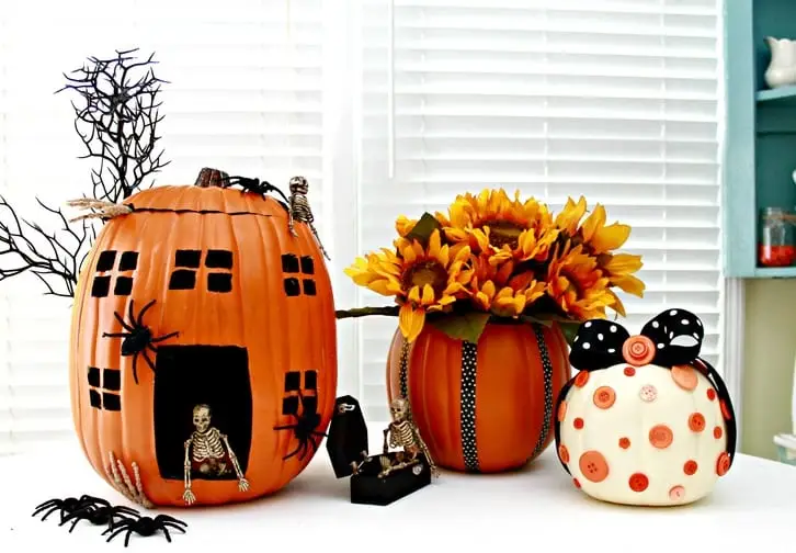 3 artificial pumpkins that have been decorated