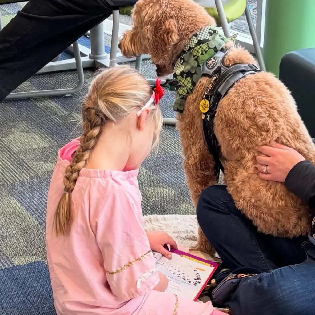 girl reading to dog