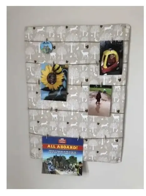 DIY photo display board made of cardboard, material, yarn and clips
