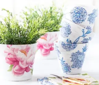 5 clay pots that have been decorated using ModPodge with pink and blue flowers