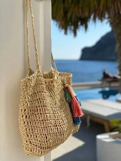 crocheted purse hanging on door by a window