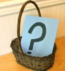 basket with a card inside that has a question mark