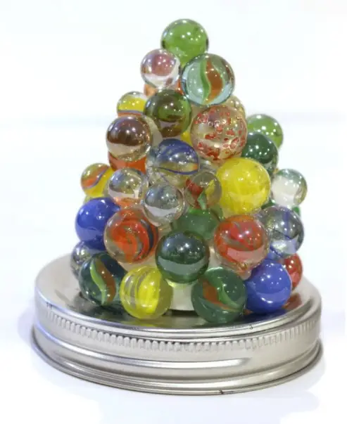 a tealight tower made of marbles and jar lid