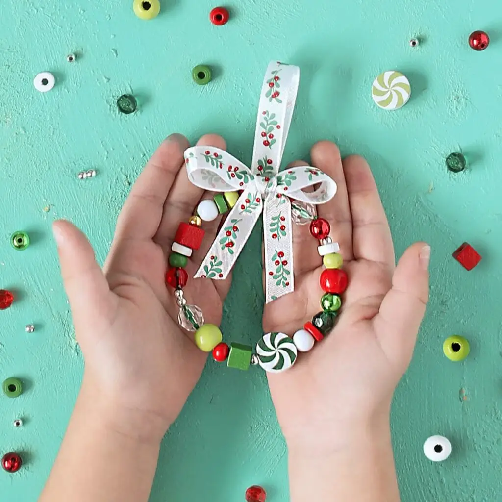 beaded wreath ornament made with pipe cleaner, holiday beads and ribbon